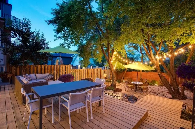 Landscaped Calgary back yard with a new lawn, walkway and fence