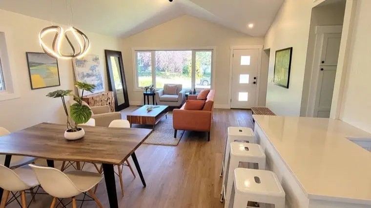 Renovated dining and living area with hardwood flooring