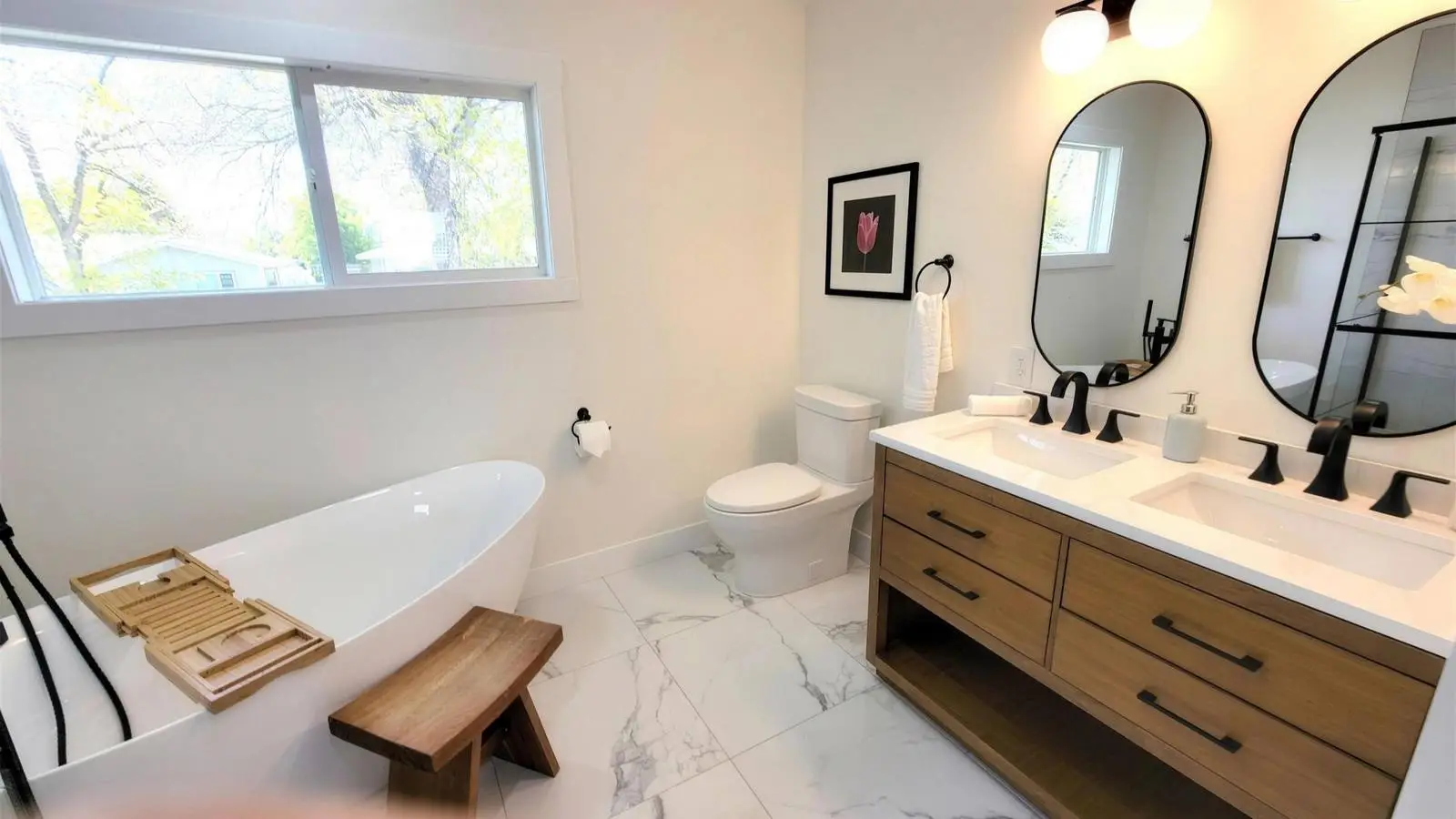The same bathroom after remodelling, with a tiled walk-in shower