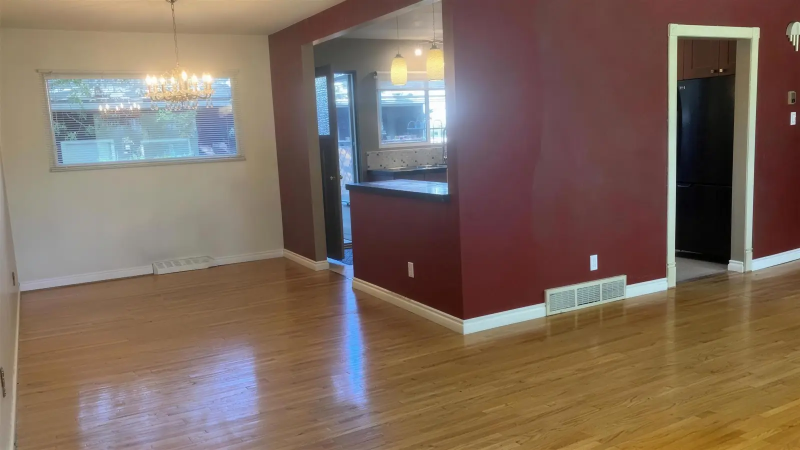 Kitchen before renovation, with dated cabinets and laminate counters