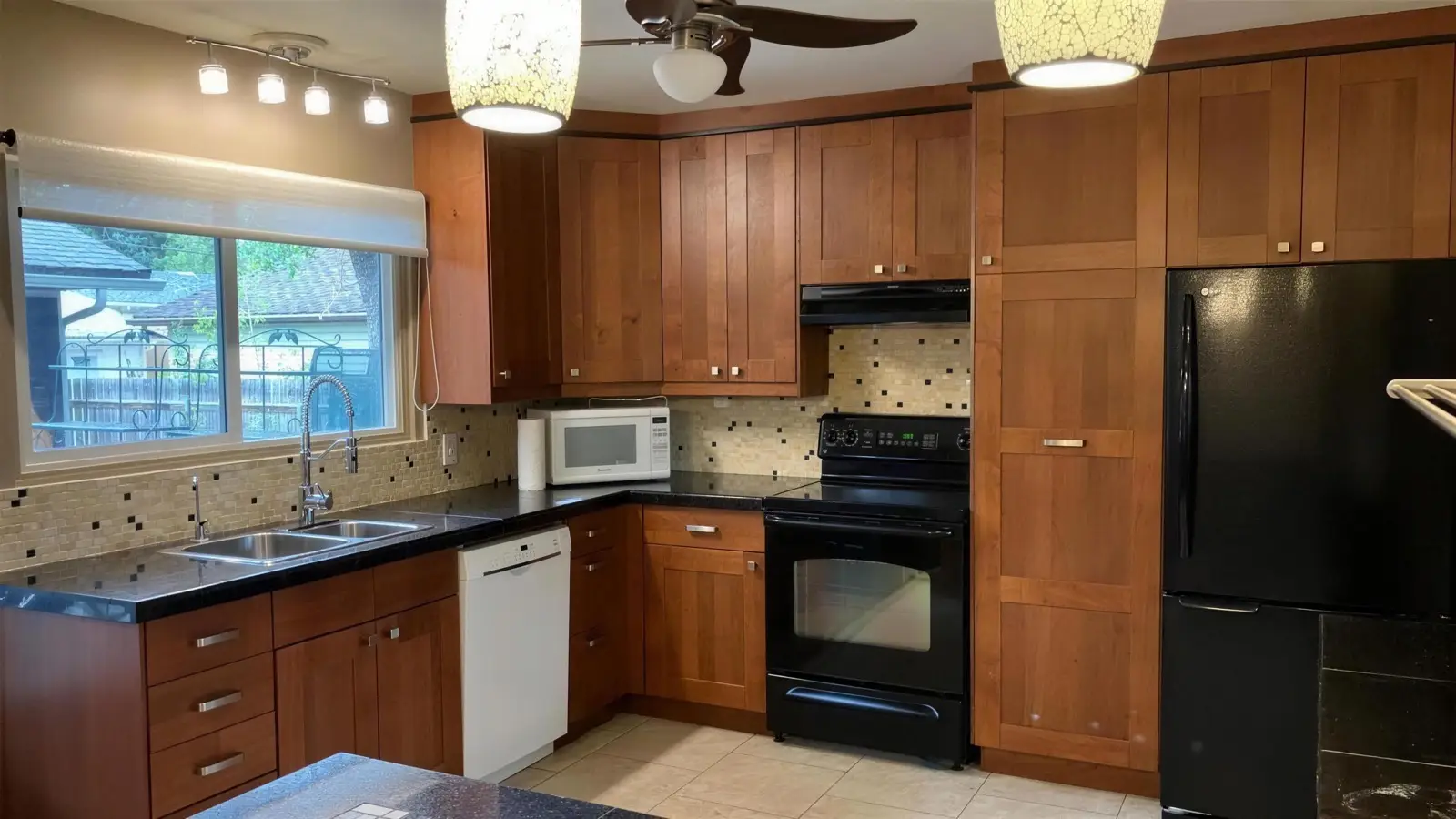 Kitchen before a refresh, with dark cabinets and a small window