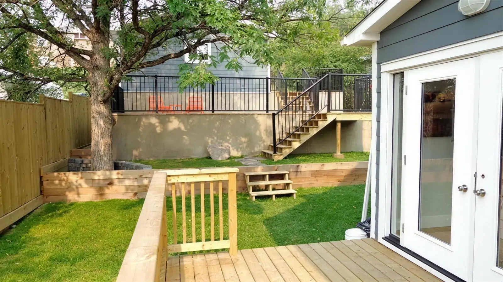 The same back yard after a new deck and lawn