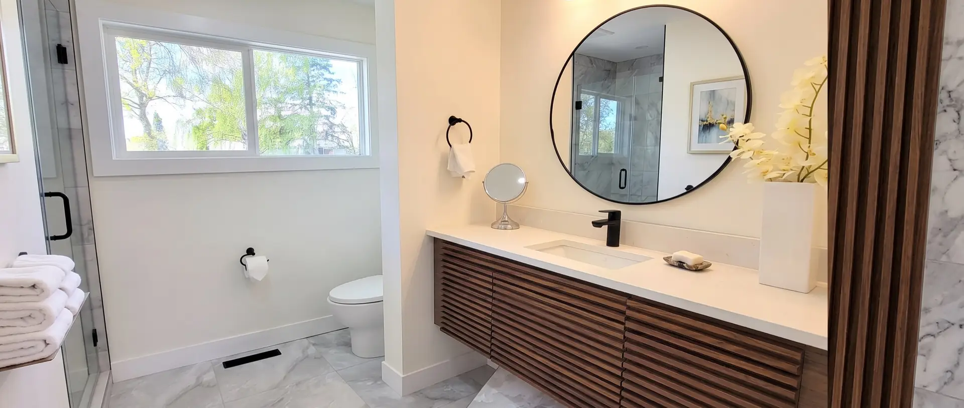 Renovated bathroom with tiled shower and vanity