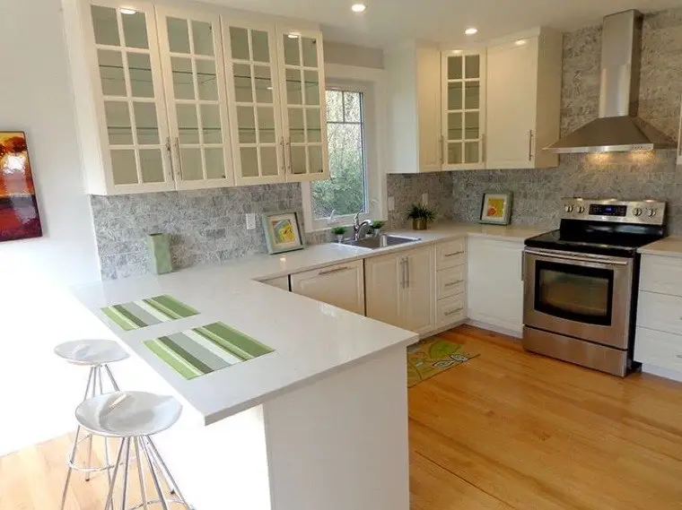 Renovated kitchen with custom cabinetry and quartz counters